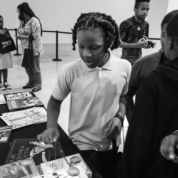 Young boy with white shirt looking at free books